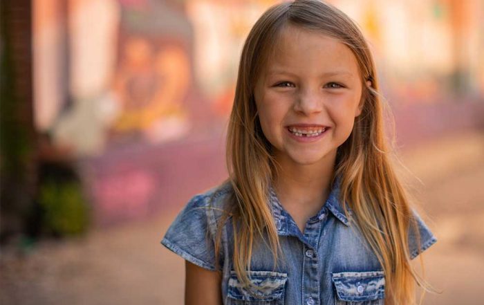 Young girl smiling with Invisalign aligners